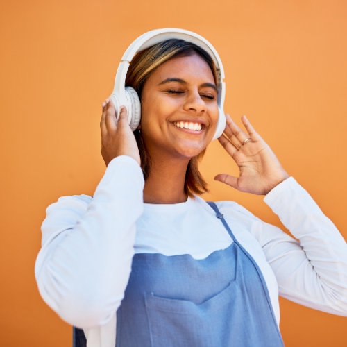 Woman listening to podcast on headphones.